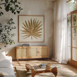 Gilded Palm VIII by Chris Paschke. Shown in a natural wood frame in a cozy modern living room. Available as an archival giclee rolled canvas, fine art paper, or poster print. SKU 57206a.