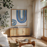 Gilded Rainbow IV by Chris Paschke. Shown in a natural wood frame in a cozy modern living room. Available as an archival giclee rolled canvas, fine art paper, or poster print. SKU 68188a.
