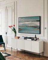 Gilded Storm III Teal Grey by Chris Paschke. shown as a framed stretched canvas in a living room above a console. Available as a archival giclee rolled canvas, fine art paper, or poster print. SKU 27535i.