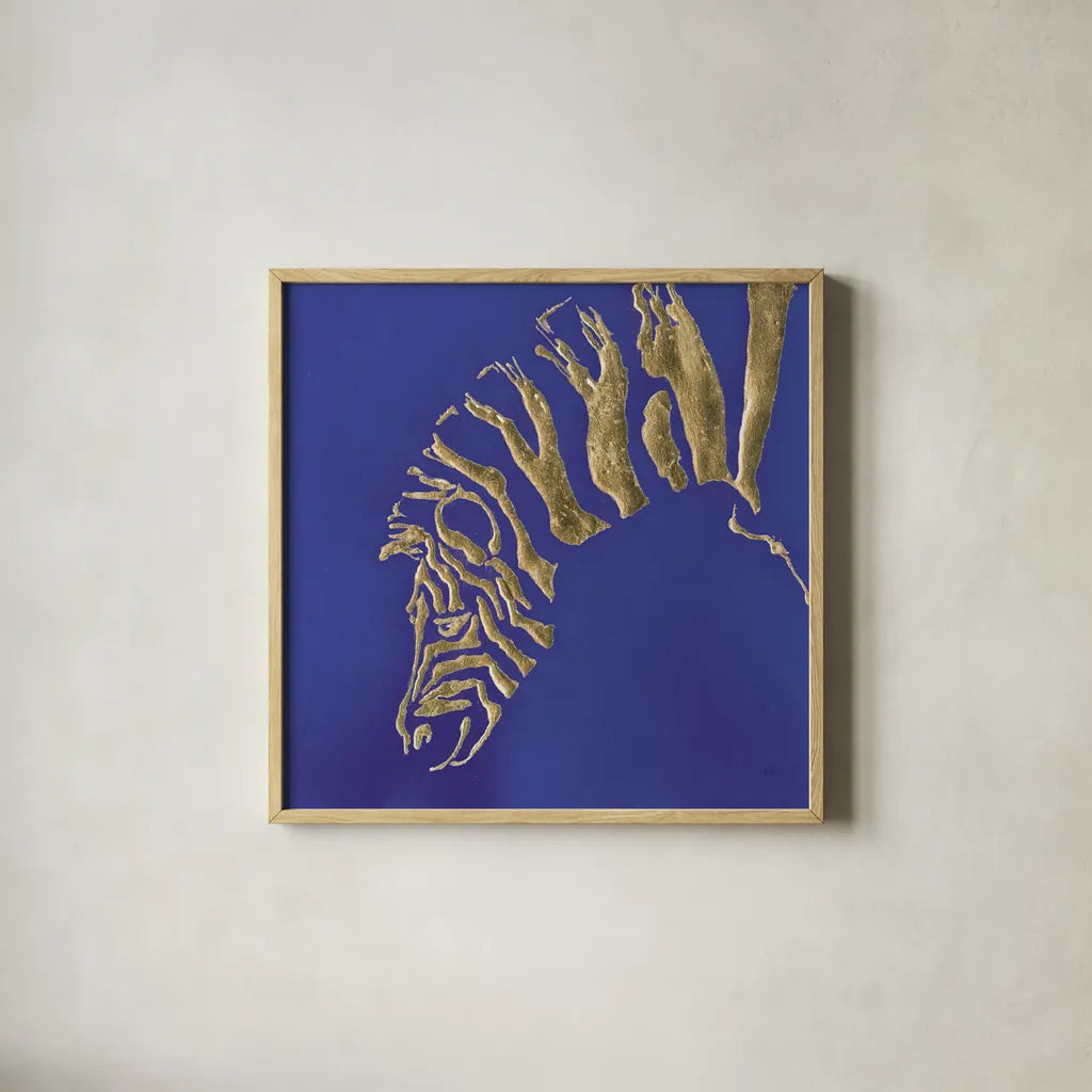 Gilded Zebra Indigo by Chris Paschke. Shown in a natural wood glass frame for a timeless modern aesthetic. Available as an archival giclee rolled canvas, fine art paper, or poster print. SKU 41920a.