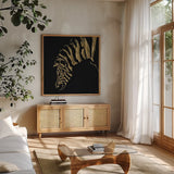 Gilded Zebra on Black by Chris Paschke. Shown in a natural wood frame in a cozy modern living room. Available as an archival giclee rolled canvas, fine art paper, or poster print. SKU 31575a.
