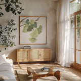 Gingko Leaves I on White by Chris Paschke. Shown in a natural wood frame in a cozy modern living room. Available as an archival giclee rolled canvas, fine art paper, or poster print. SKU 30858a.