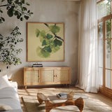 Gingko Leaves II Dark by Chris Paschke. Shown in a natural wood frame in a cozy modern living room. Available as an archival giclee rolled canvas, fine art paper, or poster print. SKU 31587a.
