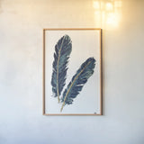 Gold Feathers IV Indigo by Chris Paschke. shown as a paper print in a natural frame. Available as a archival giclee rolled canvas, fine art paper, or poster print. SKU 26438h.
