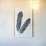 Gold Feathers IV Indigo by Chris Paschke. shown as a paper print in a white frame. Available as a archival giclee rolled canvas, fine art paper, or poster print. SKU 26438h.