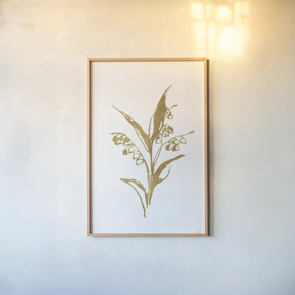 Gold Line Lily of the Valley I by Chris Paschke. shown as a paper print in a natural frame. Available as a archival giclee rolled canvas, fine art paper, or poster print. SKU 69566h.