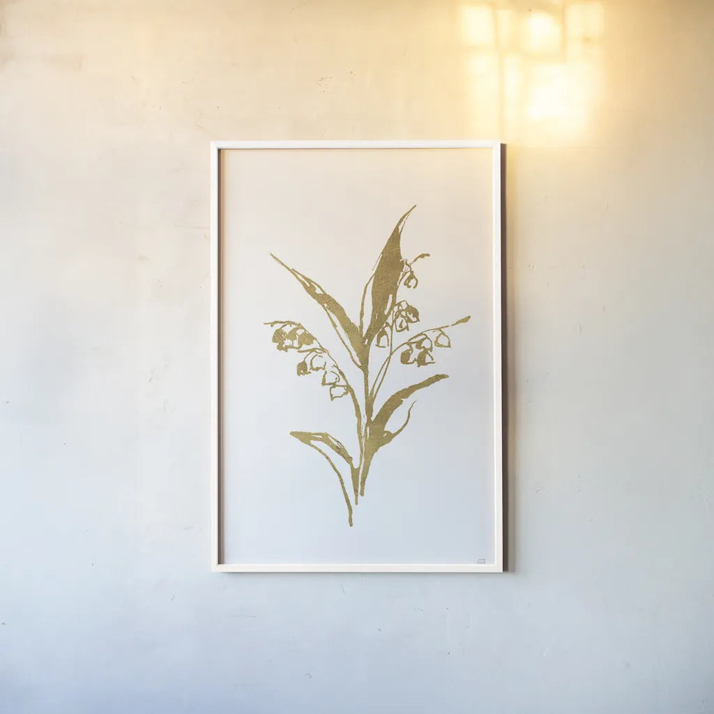 Gold Line Lily of the Valley I by Chris Paschke. shown as a paper print in a white frame. Available as a archival giclee rolled canvas, fine art paper, or poster print. SKU 69566h.