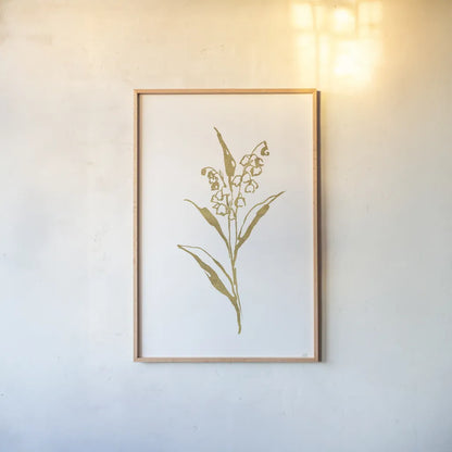 Gold Line Lily of the Valley II by Chris Paschke. shown as a paper print in a natural frame. Available as a archival giclee rolled canvas, fine art paper, or poster print. SKU 69567h.