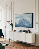 In the Blue IV by Chris Paschke. shown as a framed stretched canvas in a living room above a console. Available as a archival giclee rolled canvas, fine art paper, or poster print. SKU 61472i.