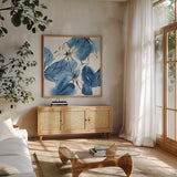 Indigo Neutrals I by Chris Paschke. Shown in a natural wood frame in a cozy modern living room. Available as an archival giclee rolled canvas, fine art paper, or poster print. SKU 70651a.