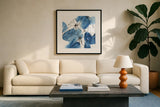 Indigo Neutrals I by Chris Paschke. Displayed in a glass frame with matte in a clean modern living room. Available as an archival giclee rolled canvas, fine art paper, or poster print. SKU 70651a.