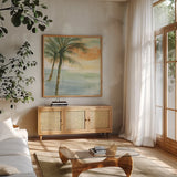 Island Sunset I by Chris Paschke. Shown in a natural wood frame in a cozy modern living room. Available as an archival giclee rolled canvas, fine art paper, or poster print. SKU 23897a.
