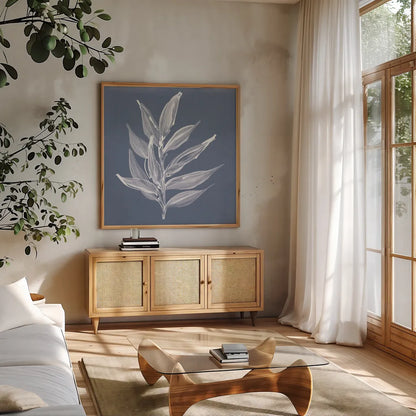Leaf Study IV Blue by Chris Paschke. Shown in a natural wood frame in a cozy modern living room. Available as an archival giclee rolled canvas, fine art paper, or poster print. SKU 80066a.