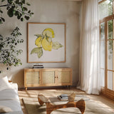 Lemons I by Chris Paschke. Shown in a natural wood frame in a cozy modern living room. Available as an archival giclee rolled canvas, fine art paper, or poster print. SKU 66876a.