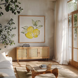 Lemons II by Chris Paschke. Shown in a natural wood frame in a cozy modern living room. Available as an archival giclee rolled canvas, fine art paper, or poster print. SKU 66877a.