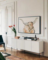 Longhorn I by Chris Paschke. shown as a framed stretched canvas in a living room above a console. Available as a archival giclee rolled canvas, fine art paper, or poster print. SKU 53313i.