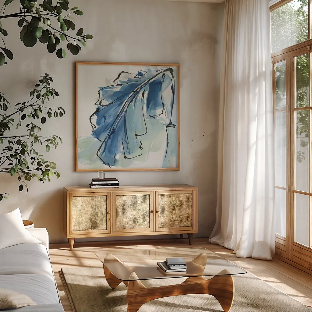 Luxe Banana Leaf III by Chris Paschke. Shown in a natural wood frame in a cozy modern living room. Available as an archival giclee rolled canvas, fine art paper, or poster print. SKU 84578a.