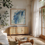 Luxe Banana Leaf III by Chris Paschke. Shown in a natural wood frame in a cozy modern living room. Available as an archival giclee rolled canvas, fine art paper, or poster print. SKU 84578a.