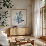 Luxe Leaf I by Chris Paschke. Shown in a natural wood frame in a cozy modern living room. Available as an archival giclee rolled canvas, fine art paper, or poster print. SKU 84572a.
