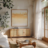 Neutral Turmeric II by Chris Paschke. Shown in a natural wood frame in a cozy modern living room. Available as an archival giclee rolled canvas, fine art paper, or poster print. SKU 68158a.