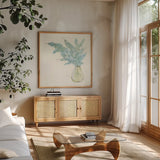 Plant Eucalyptus I by Chris Paschke. Shown in a natural wood frame in a cozy modern living room. Available as an archival giclee rolled canvas, fine art paper, or poster print. SKU 55033a.