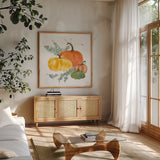 Pumpkins and Eucalyptus I by Chris Paschke. Shown in a natural wood frame in a cozy modern living room. Available as an archival giclee rolled canvas, fine art paper, or poster print. SKU 81864a.