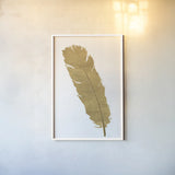 Pure Gold Feather V by Chris Paschke. shown as a paper print in a white frame. Available as a archival giclee rolled canvas, fine art paper, or poster print. SKU 28003h.