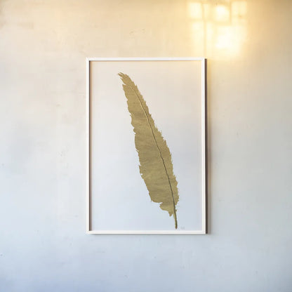 Pure Gold Feather VI by Chris Paschke. shown as a paper print in a white frame. Available as a archival giclee rolled canvas, fine art paper, or poster print. SKU 28004h.