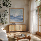 Sailboats III by Chris Paschke. Shown in a natural wood frame in a cozy modern living room. Available as an archival giclee rolled canvas, fine art paper, or poster print. SKU 73876a.