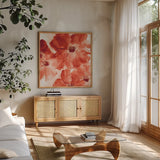 Seashell Cosmos I Red and Orange by Chris Paschke. Shown in a natural wood frame in a cozy modern living room. Available as an archival giclee rolled canvas, fine art paper, or poster print. SKU 31299a.