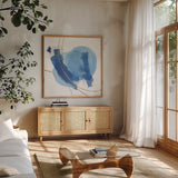 Serenity Mirage I by Chris Paschke. Shown in a natural wood frame in a cozy modern living room. Available as an archival giclee rolled canvas, fine art paper, or poster print. SKU 85753a.