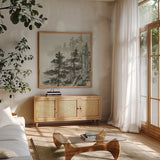 Sumi Treetops Sq by Chris Paschke. Shown in a natural wood frame in a cozy modern living room. Available as an archival giclee rolled canvas, fine art paper, or poster print. SKU 25171a.