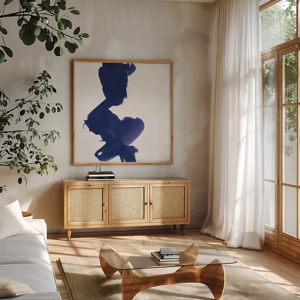 Swash II Indigo by Chris Paschke. Shown in a natural wood frame in a cozy modern living room. Available as an archival giclee rolled canvas, fine art paper, or poster print. SKU 68773a.