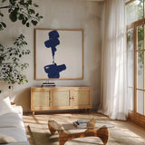 Swash III Indigo by Chris Paschke. Shown in a natural wood frame in a cozy modern living room. Available as an archival giclee rolled canvas, fine art paper, or poster print. SKU 68774a.