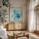 Teal Cosmos II by Chris Paschke. Shown in a natural wood frame in a cozy modern living room. Available as an archival giclee rolled canvas, fine art paper, or poster print. SKU 34005a.