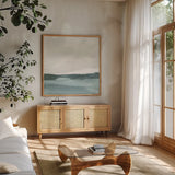 Tranquil Silver Sea I by Chris Paschke. Shown in a natural wood frame in a cozy modern living room. Available as an archival giclee rolled canvas, fine art paper, or poster print. SKU 85288a.