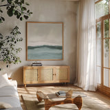 Tranquil Silver Sea II by Chris Paschke. Shown in a natural wood frame in a cozy modern living room. Available as an archival giclee rolled canvas, fine art paper, or poster print. SKU 85289a.