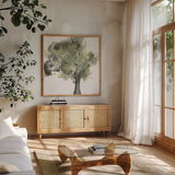 Treetops II Sage by Chris Paschke. Shown in a natural wood frame in a cozy modern living room. Available as an archival giclee rolled canvas, fine art paper, or poster print. SKU 88711a.
