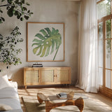 Tropical Palm IV by Chris Paschke. Shown in a natural wood frame in a cozy modern living room. Available as an archival giclee rolled canvas, fine art paper, or poster print. SKU 22676a.