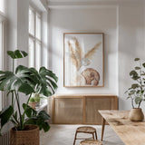 Vase Gray Lotus Pods by Chris Paschke. shown as a print in a natural wood frame in a dining room. Available as a archival giclee rolled canvas, fine art paper, or poster print. SKU 75455h.