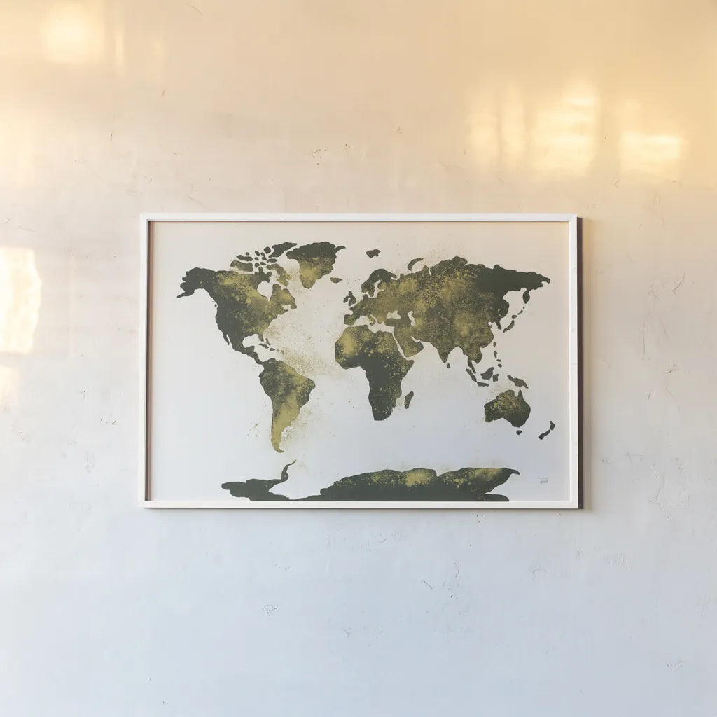 World Map Gold Dust by Chris Paschke. shown as a paper print in a white frame. Available as a archival giclee rolled canvas, fine art paper, or poster print. SKU 53224i.