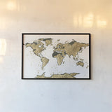 World Map Gold Leaf by Chris Paschke. shown as a paper print in a black flame. Available as a archival giclee rolled canvas, fine art paper, or poster print. SKU 53225i.