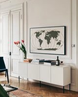 World Map Gold Lines by Chris Paschke. shown as a framed stretched canvas in a living room above a console. Available as a archival giclee rolled canvas, fine art paper, or poster print. SKU 53223i.