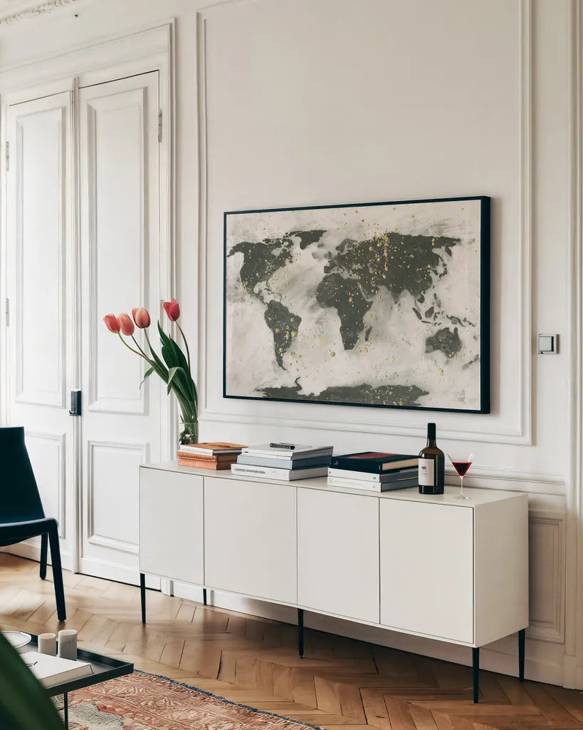World Map Gold Speckle by Chris Paschke. shown as a framed stretched canvas in a living room above a console. Available as a archival giclee rolled canvas, fine art paper, or poster print. SKU 53226i.