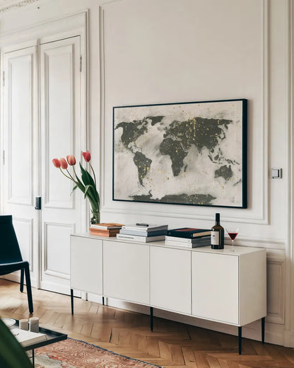 World Map Gold Speckle by Chris Paschke. shown as a framed stretched canvas in a living room above a console. Available as a archival giclee rolled canvas, fine art paper, or poster print. SKU 53226i.