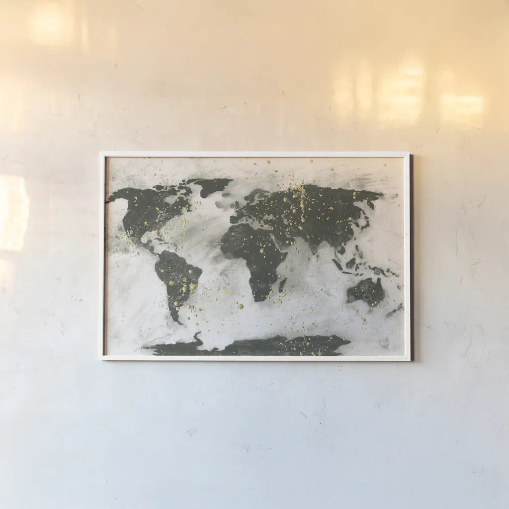 World Map Gold Speckle by Chris Paschke. shown as a paper print in a white frame. Available as a archival giclee rolled canvas, fine art paper, or poster print. SKU 53226i.
