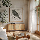 Bird Element I by Courtney Prahl. Shown in a natural wood frame in a cozy modern living room. Available as an archival giclee rolled canvas, fine art paper, or poster print. SKU 30365a.