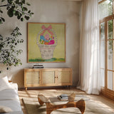Easter Basket Delight Square by Courtney Prahl. Shown in a natural wood frame in a cozy modern living room. Available as an archival giclee rolled canvas, fine art paper, or poster print. SKU 52383a.