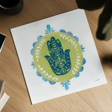 Hamsa Mandala II by Courtney Prahl. Shown as a detailed flat fine art print, highlighting archival giclee quality. Available as an archival giclee rolled canvas, fine art paper, or poster print. SKU 76298a.