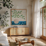 Joyful Leaves by Courtney Prahl. Shown in a natural wood frame in a cozy modern living room. Available as an archival giclee rolled canvas, fine art paper, or poster print. SKU 97649a.